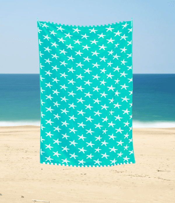 large beach towel luxury soft feel with star fish ocean pattern on a blue teal background with white reverse