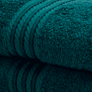 Peacock teal Blue Egyptian Cotton Towels stacked neatly in bathroom Teal 500GSM cotton towel draped over bath edge Luxury Peacock Blue hand towel folded on countertop Close-up of soft Egyptian cotton towel in rich teal colour Peacock towel set – face cloth, hand towel, bath towel, bath sheet