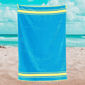 blue & yellow beach towel on the beach large luxury velour beach towels uk