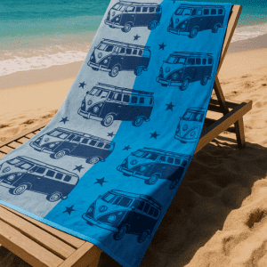 blue beach towel with camper van pattern at sunny beach on sunlounger