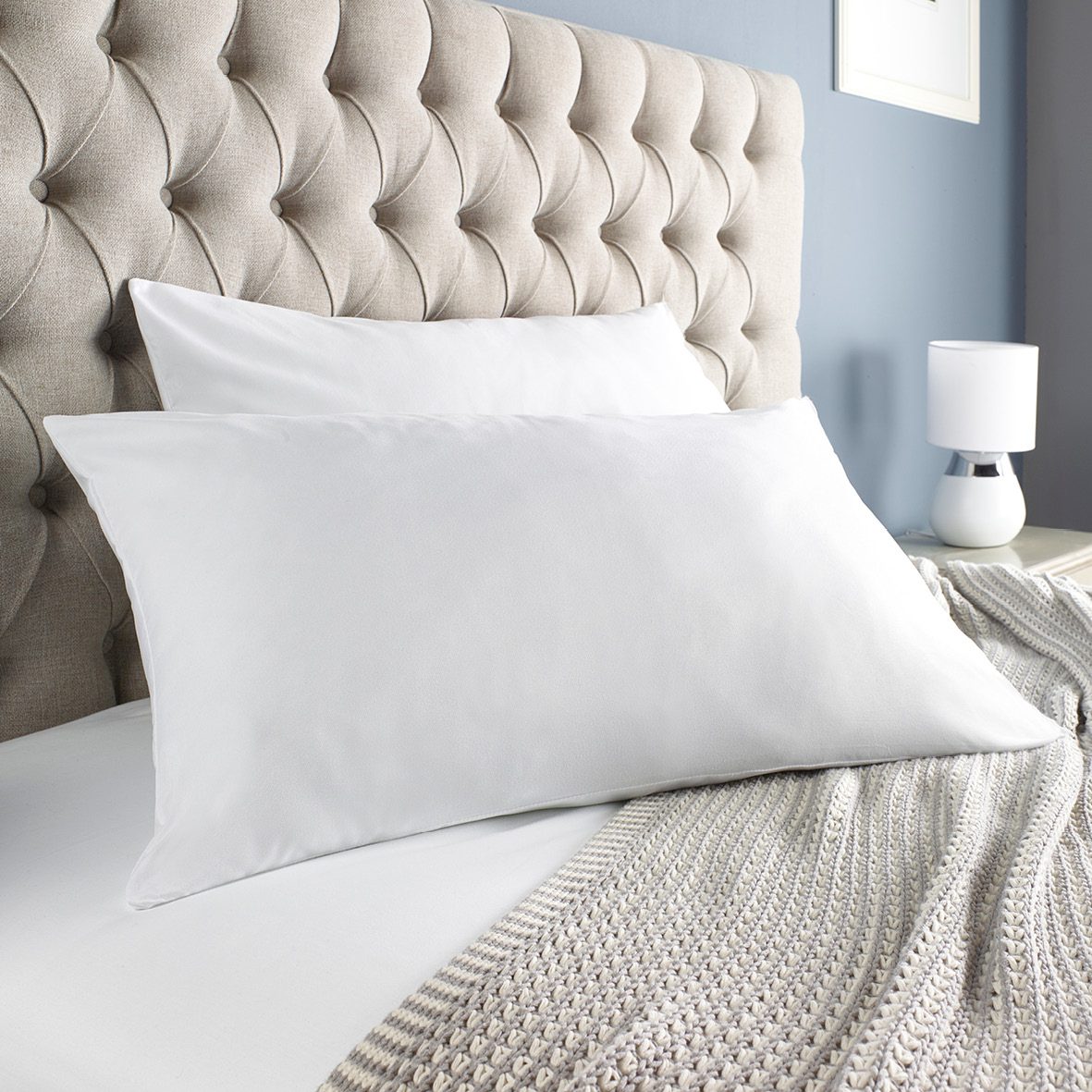 Eco-friendly pillows on bed – affordable sustainable bedding made from recycled bottles