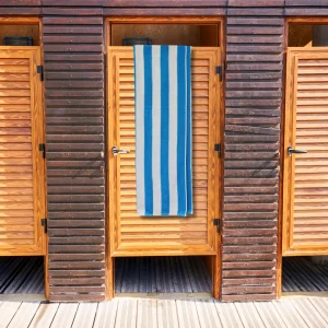 bright blue striped towel hanging over wooden door
