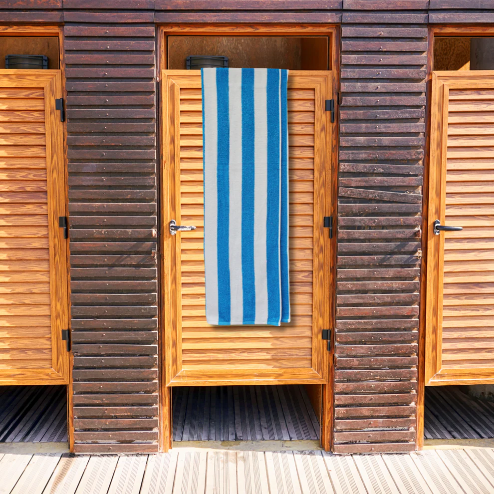 bright blue striped towel hanging over wooden door